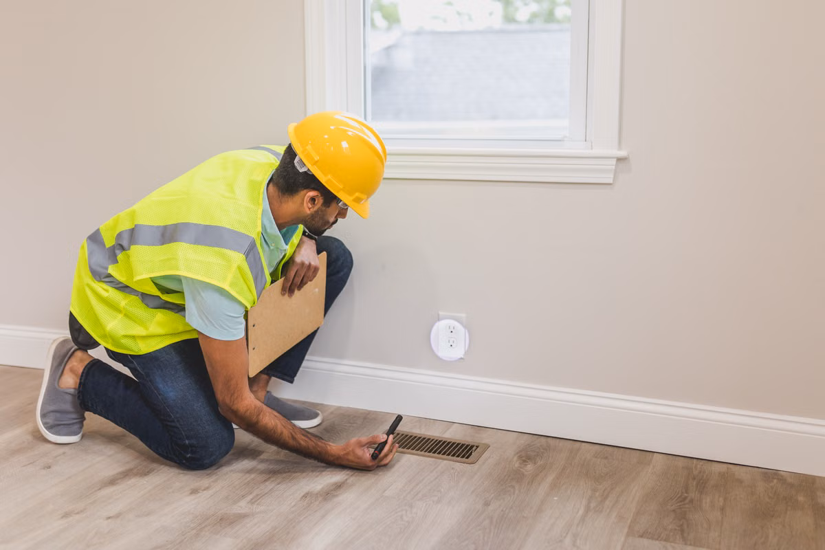 Technician checking air and moisture conditions in a dry residential crawlspace